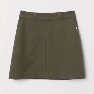 H&M green mini skirt. Size 4 . New.